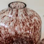Brown vase styled with neutral home d√©cor