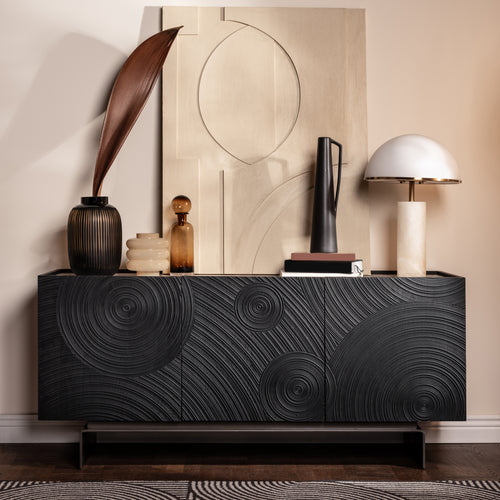 Decorative sideboard with artistic design against a neutral wall. Natural ceramic top.