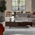 Modern living room with a sectional sofa, coffee table, and decorative items.