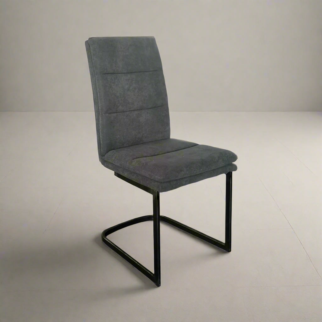 Gray upholstered chair with black metal legs on a white background